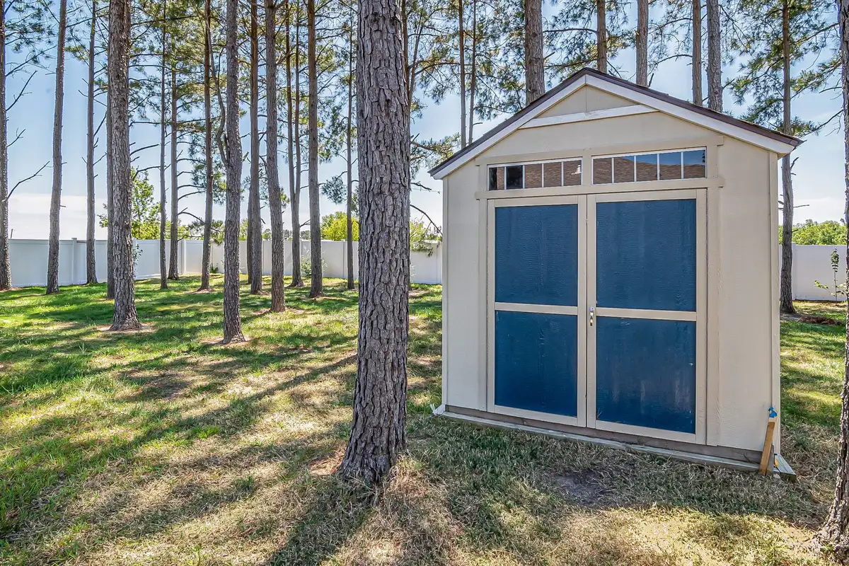 A wooden storage shed in a backyard